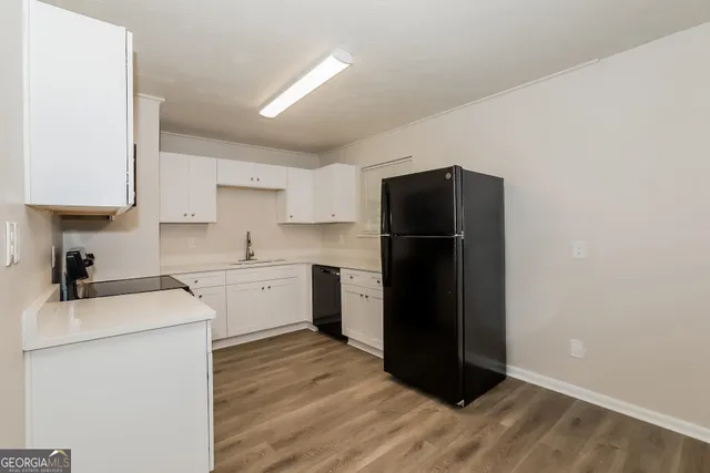 a kitchen with cabinets stainless steel appliances and sink