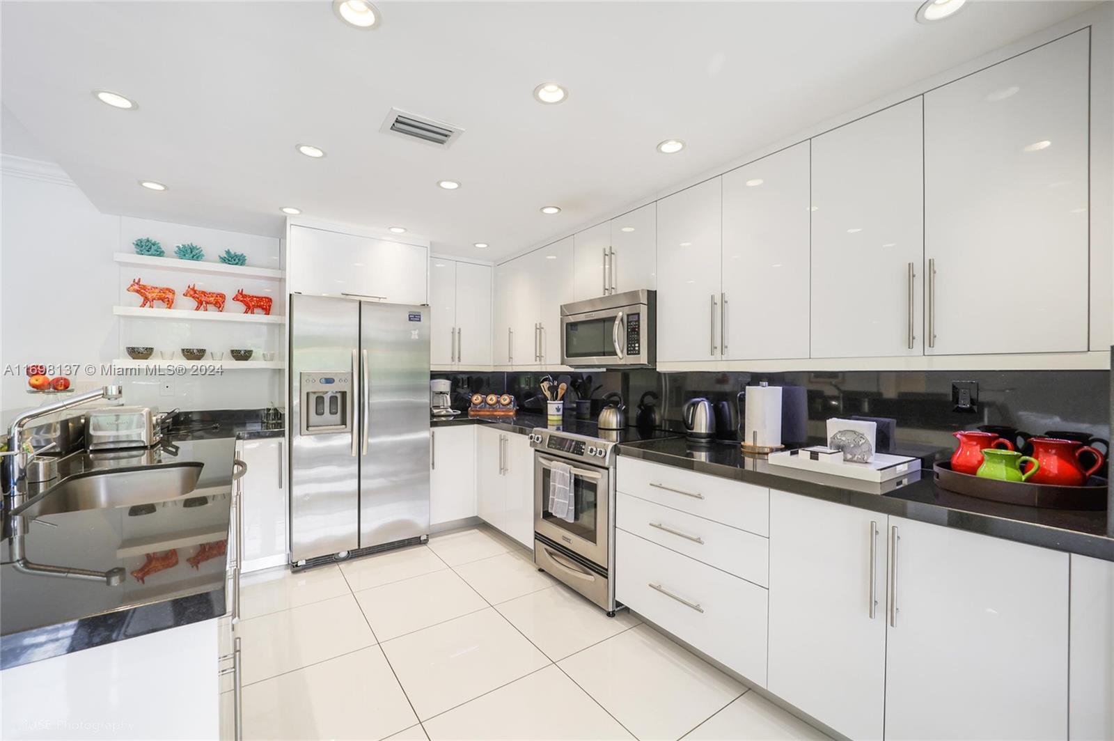 Key Biscayne Key Biscayne, FL 33149 - Photo 5 of 12 a kitchen with stainless steel appliances granite countertop a refrigerator sink and cabinets
