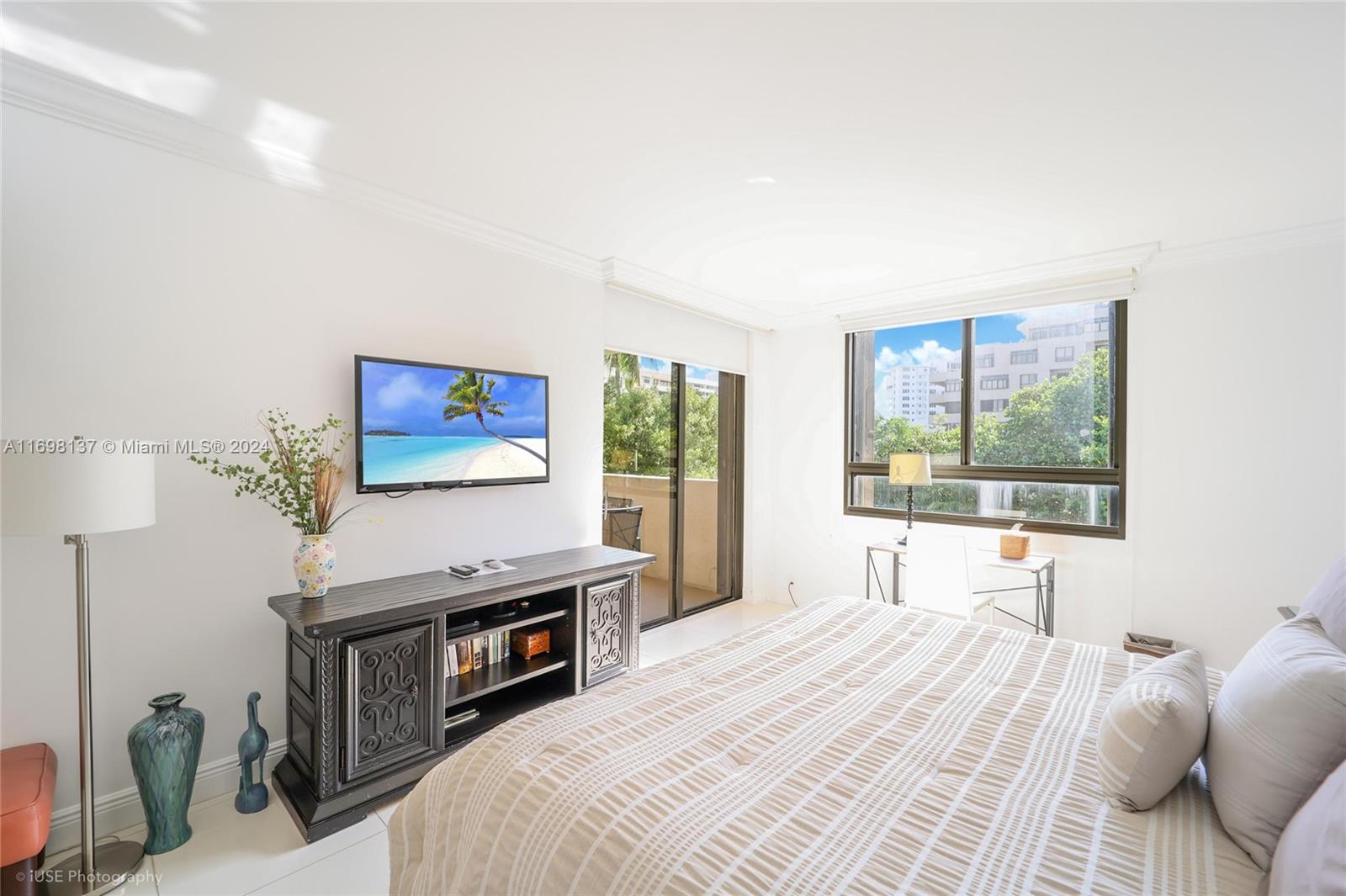 Key Biscayne Key Biscayne, FL 33149 - Photo 6 of 12 a bedroom with a bed and a flat screen tv