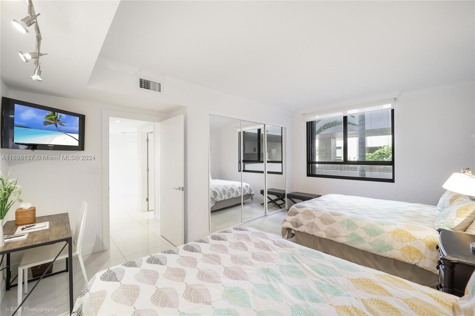 Key Biscayne Key Biscayne, FL 33149 - Photo 8 of 12 a bedroom with a bed and a window