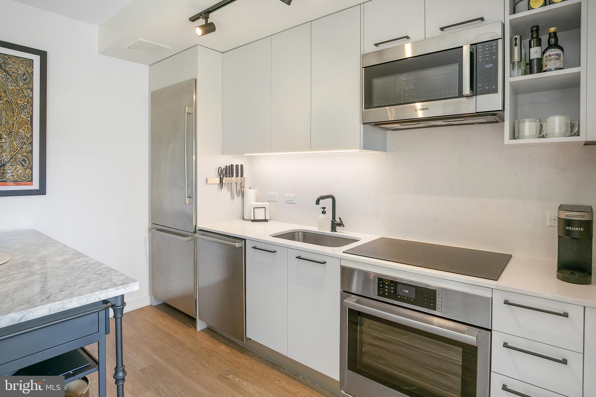 1625 Eckington Place Northeast, Unit 421 Washington, DC 20002 - Photo 8 of 40 a kitchen with a sink and a microwave