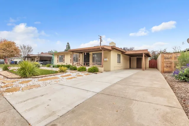 a front view of a house with a garden