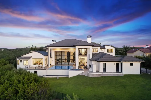 a front view of a house with a garden and yard