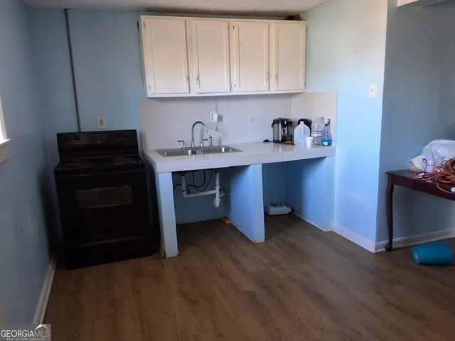a kitchen with sink and cabinets