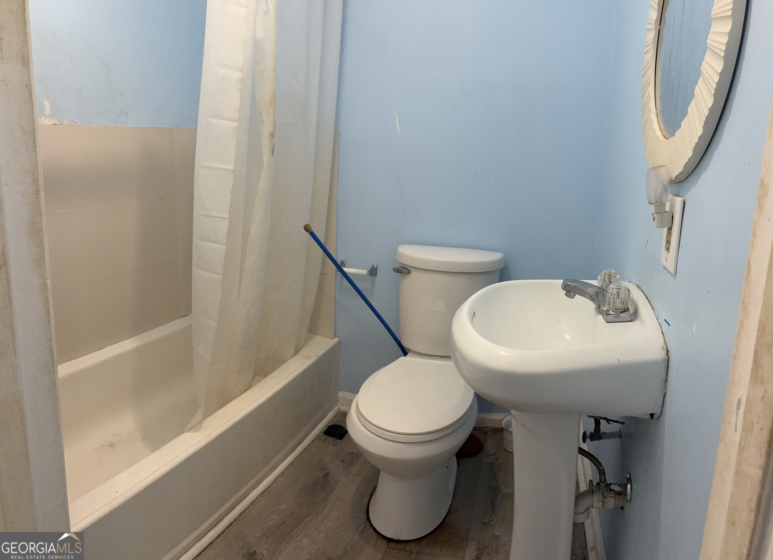 745 Pebble Street Macon, GA 31201 - Photo 8 of 10 a white toilet sitting next to a bathroom sink and tub