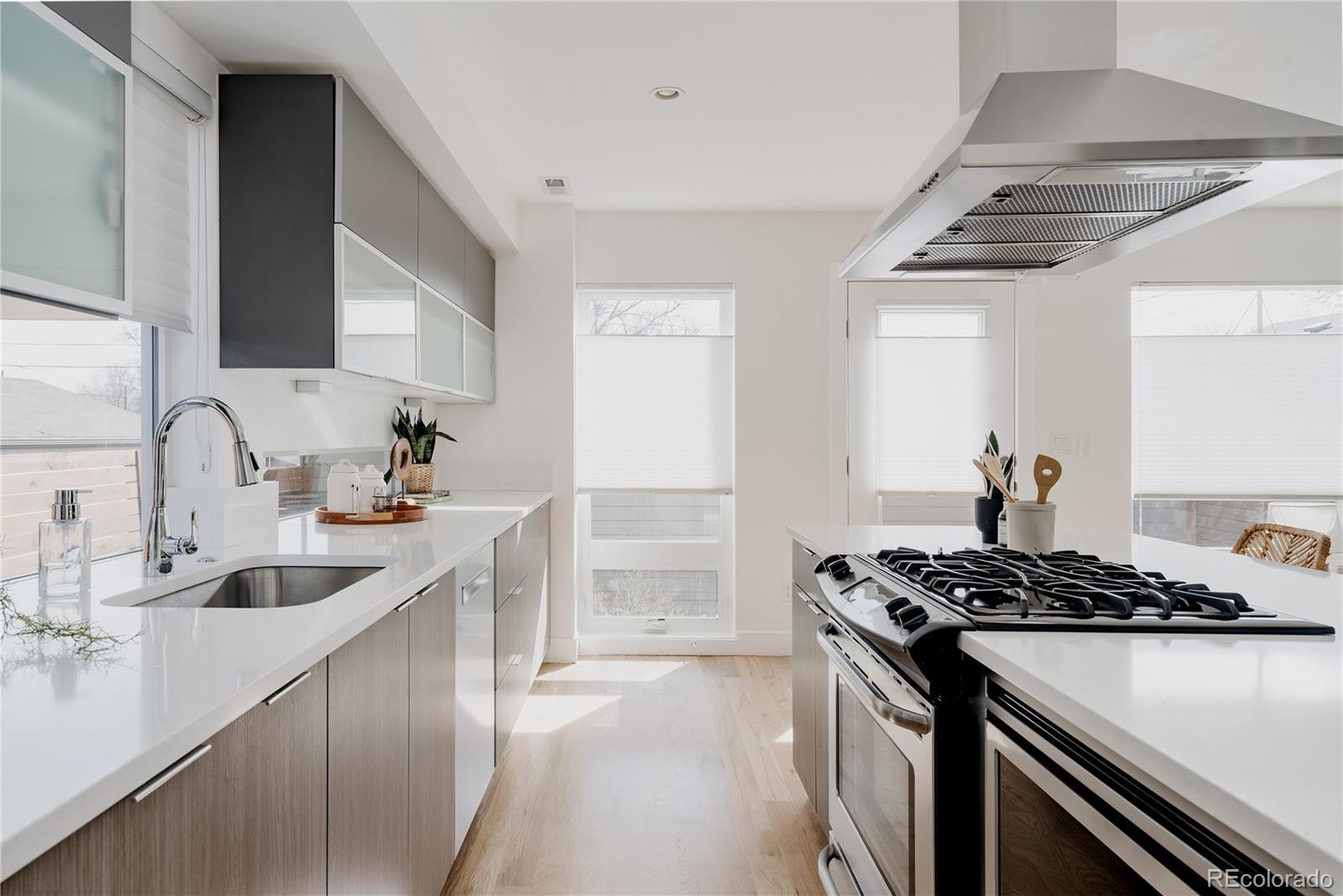 3724 Quivas Street Denver, CO 80211 - Photo 12 of 46 a kitchen that has a sink and a stove