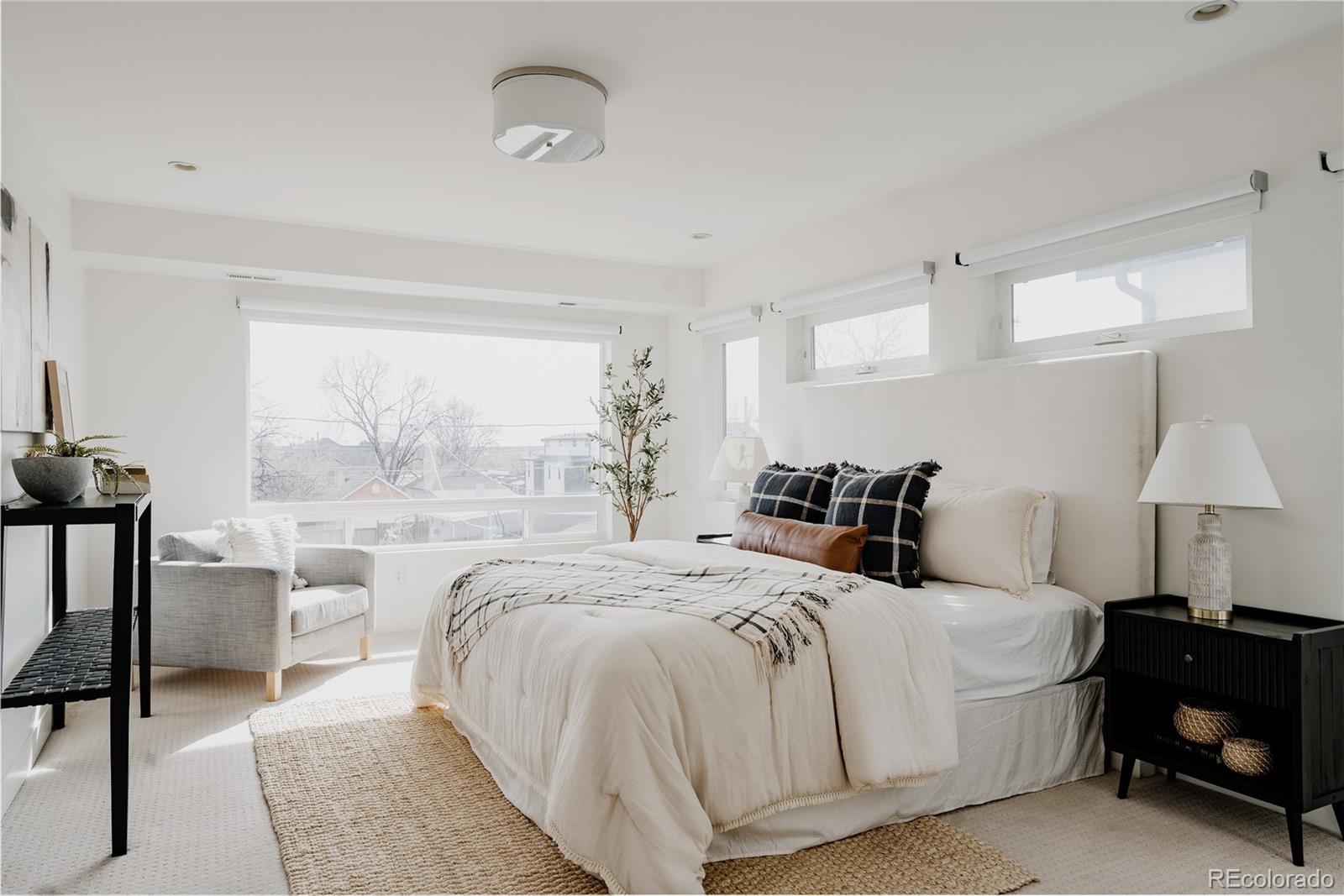3724 Quivas Street Denver, CO 80211 - Photo 16 of 46 a spacious bedroom with a bed and a lamp