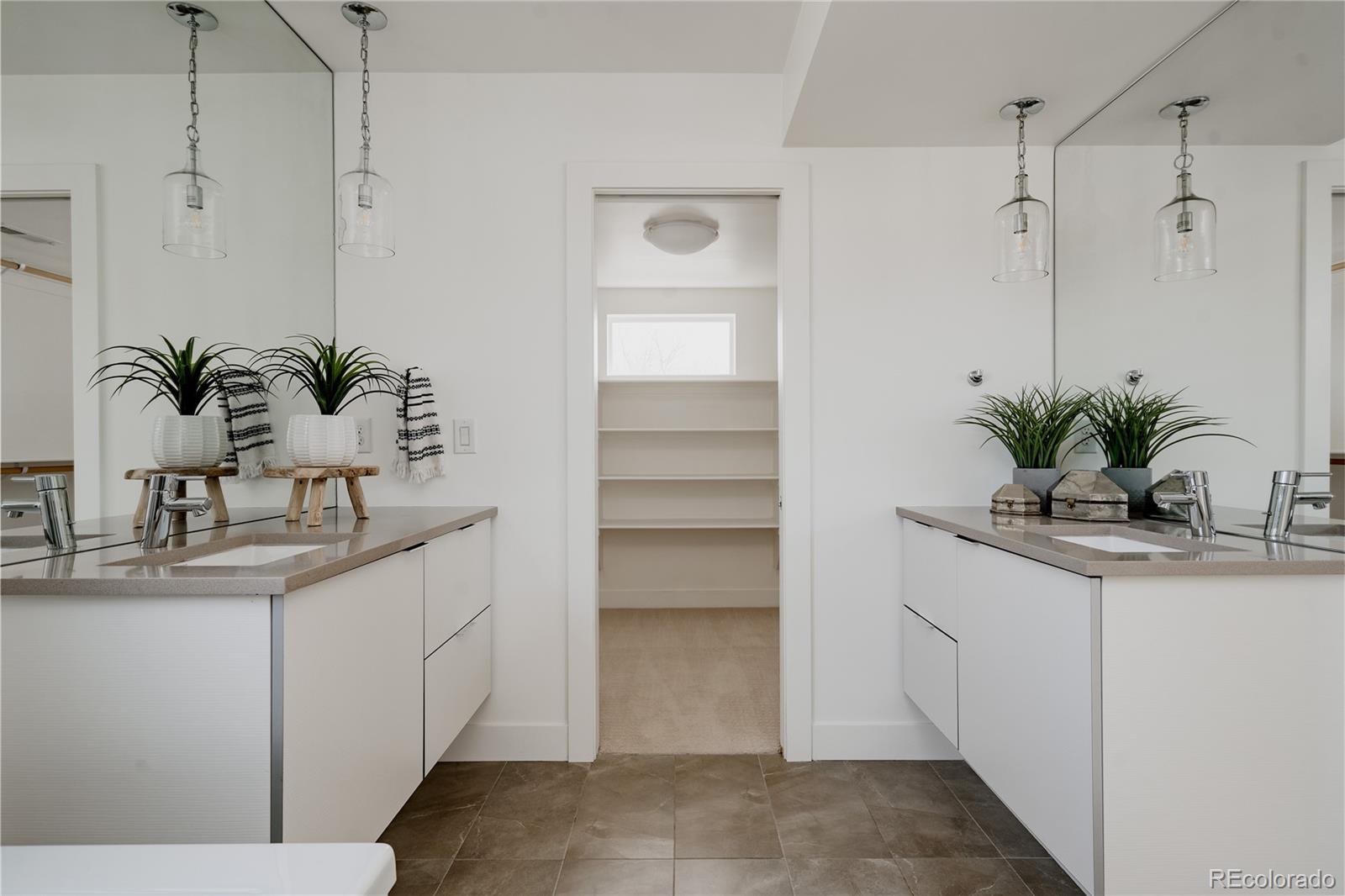 3724 Quivas Street Denver, CO 80211 - Photo 20 of 46 a bathroom with a granite countertop sink a mirror and a potted plant