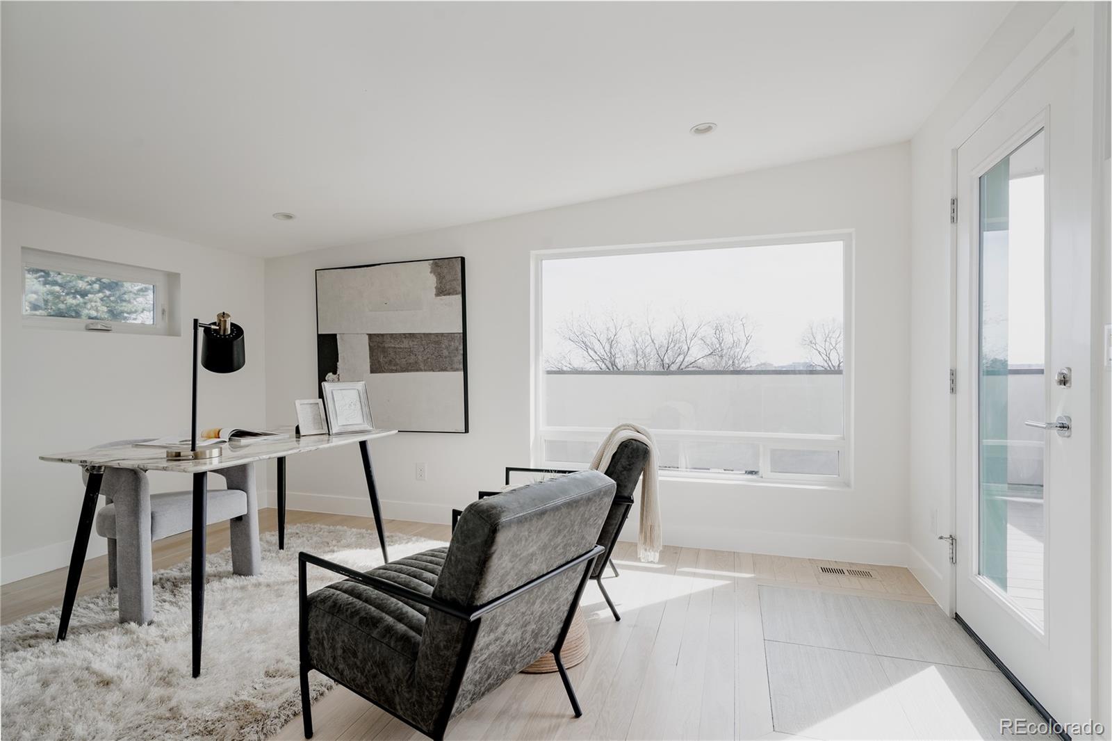 3724 Quivas Street Denver, CO 80211 - Photo 25 of 46 a living room with furniture and a floor to ceiling window