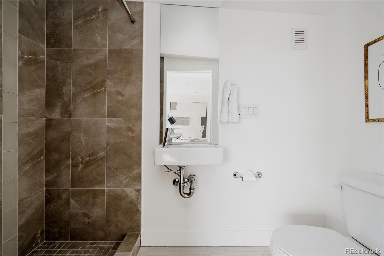 3724 Quivas Street Denver, CO 80211 - Photo 26 of 46 a bathroom with a shower and toilet