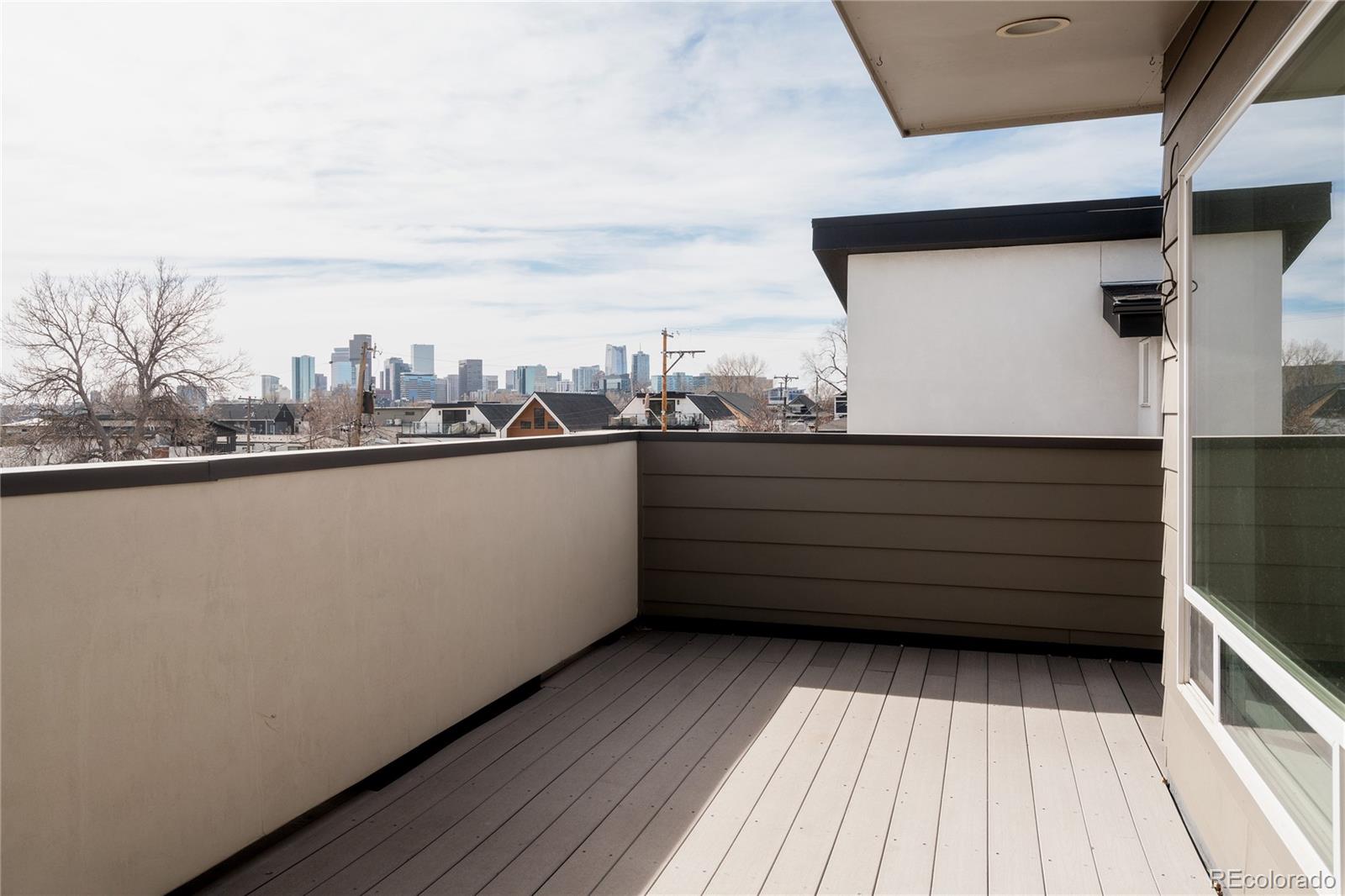 3724 Quivas Street Denver, CO 80211 - Photo 29 of 46 a view of a balcony with wooden floor and fence in the background