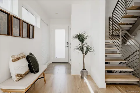a view of hallway with furniture and wooden floor