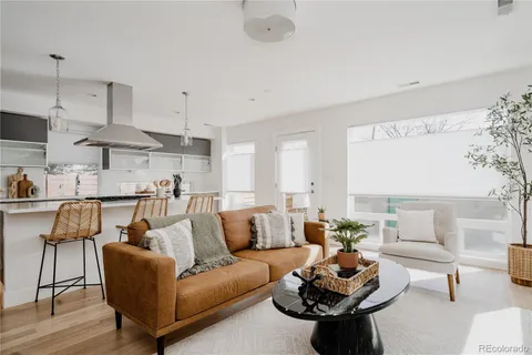 a living room with furniture and kitchen view