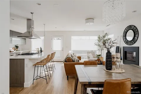 a living room with furniture a dining table and a fireplace