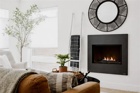 a living room with furniture a fireplace and a chandelier