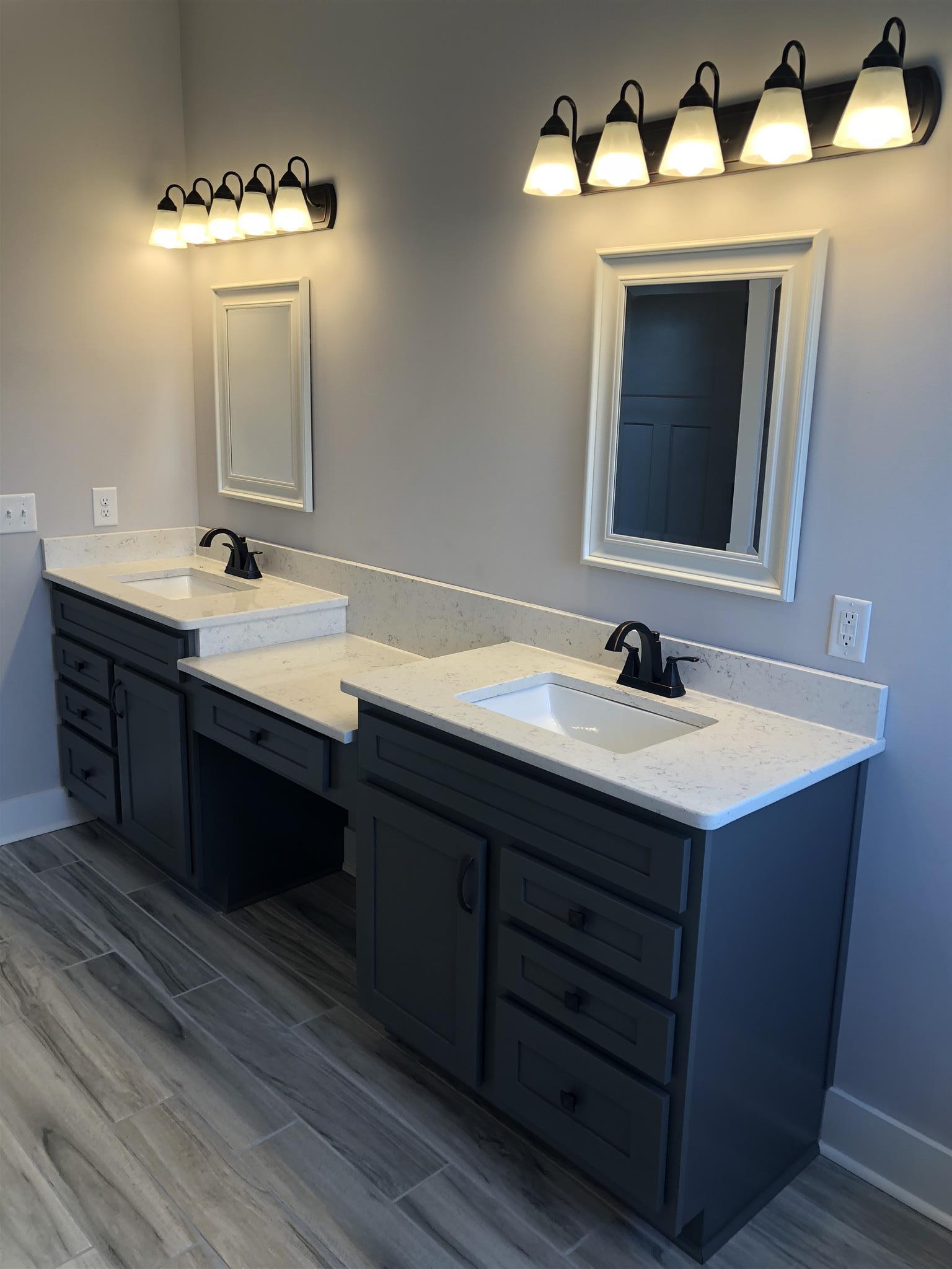 409 Halltown Road Cottontown, TN 37048 - Photo 18 of 25 a bathroom with a double vanity sink and a mirror
