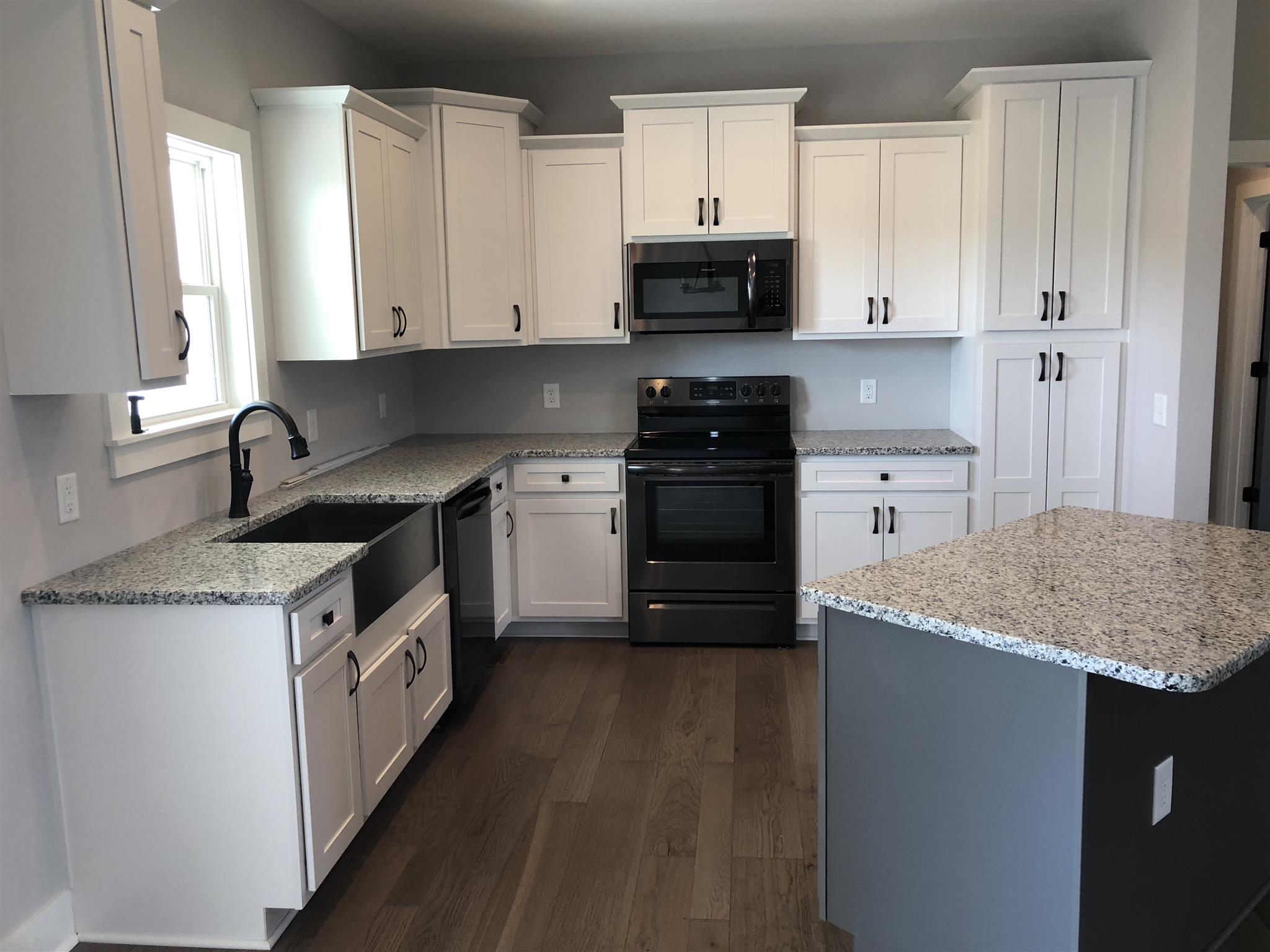 409 Halltown Road Cottontown, TN 37048 - Photo 2 of 25 a kitchen with stainless steel appliances granite countertop a sink stove and cabinets