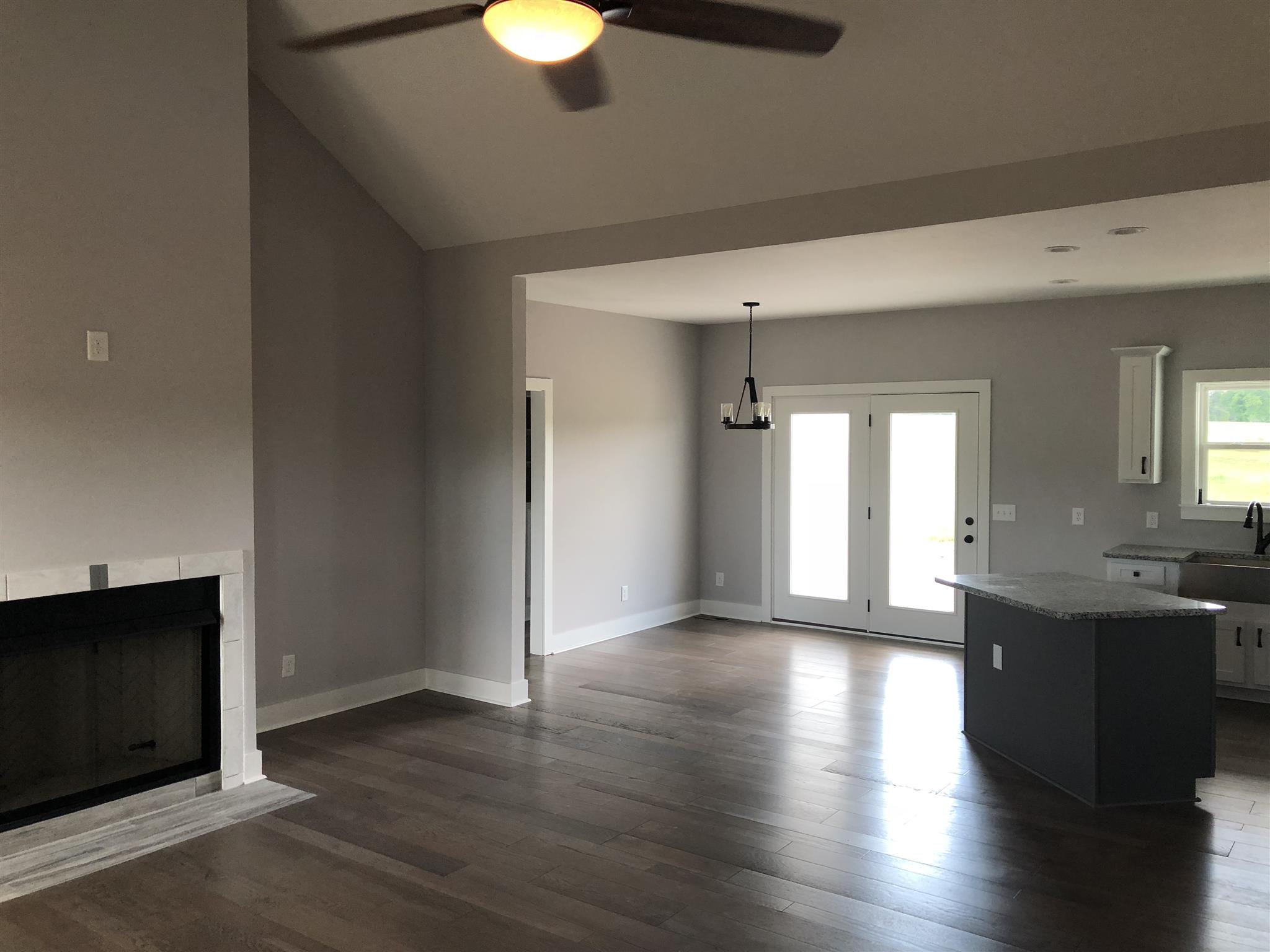 409 Halltown Road Cottontown, TN 37048 - Photo 25 of 25 an empty room with wooden floor and windows