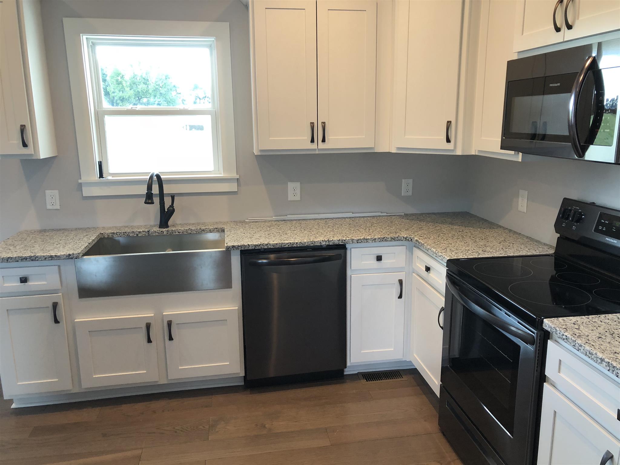 409 Halltown Road Cottontown, TN 37048 - Photo 22 of 25 a kitchen with granite countertop white cabinets and a stove