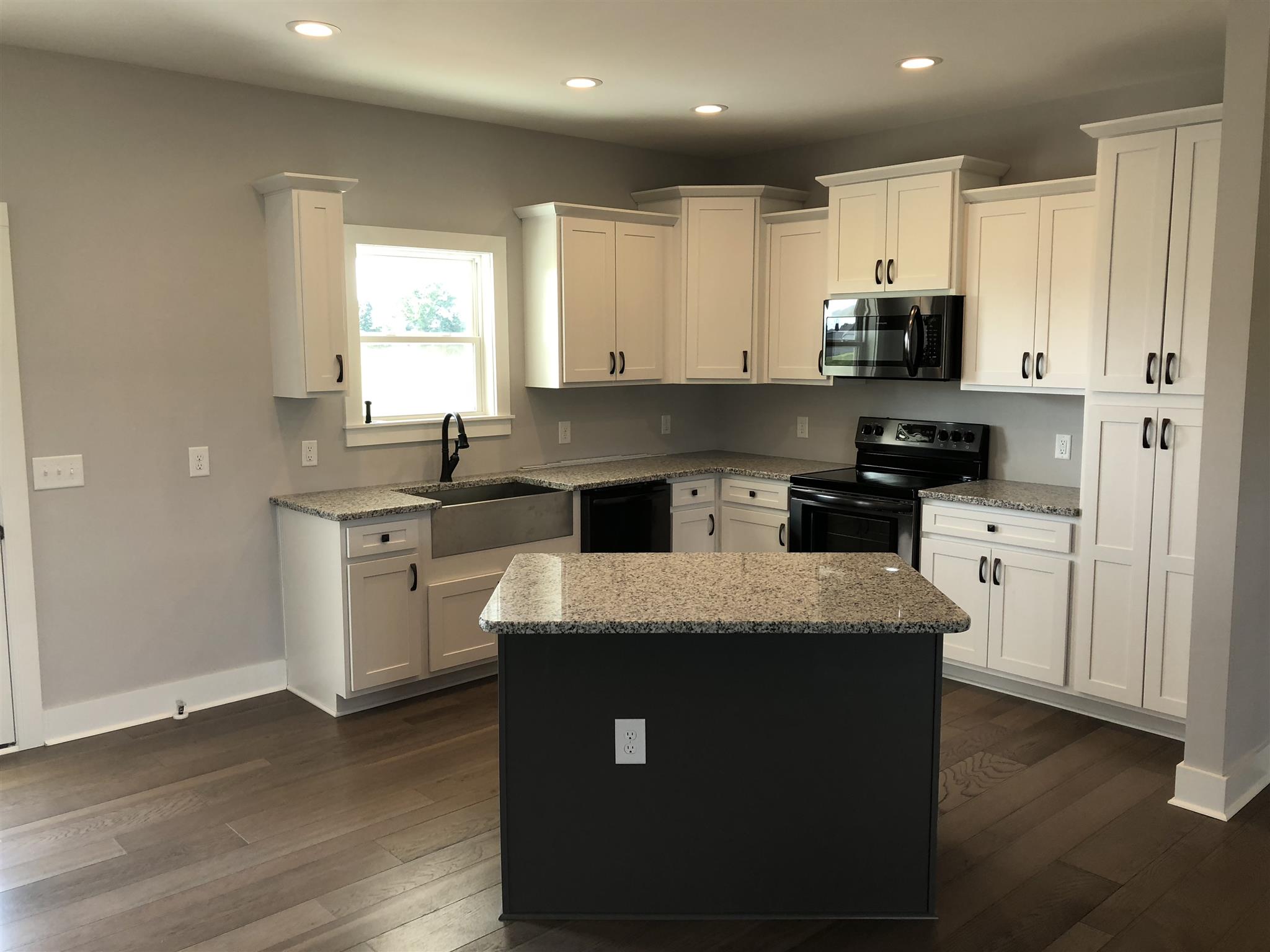 409 Halltown Road Cottontown, TN 37048 - Photo 3 of 25 a kitchen with stainless steel appliances granite countertop a sink stove and refrigerator