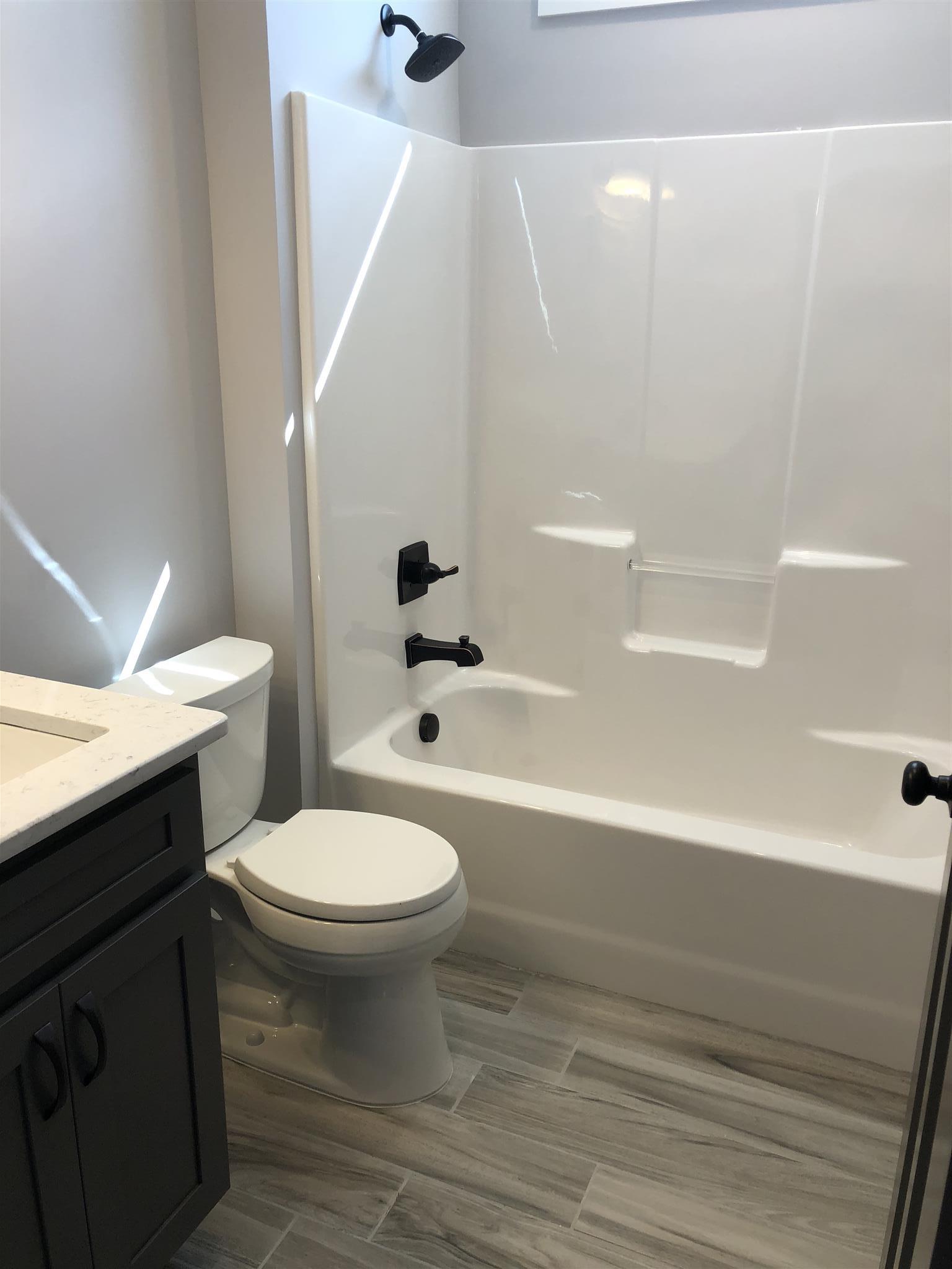 409 Halltown Road Cottontown, TN 37048 - Photo 7 of 25 a bathroom with a sink a toilet and a bathtub