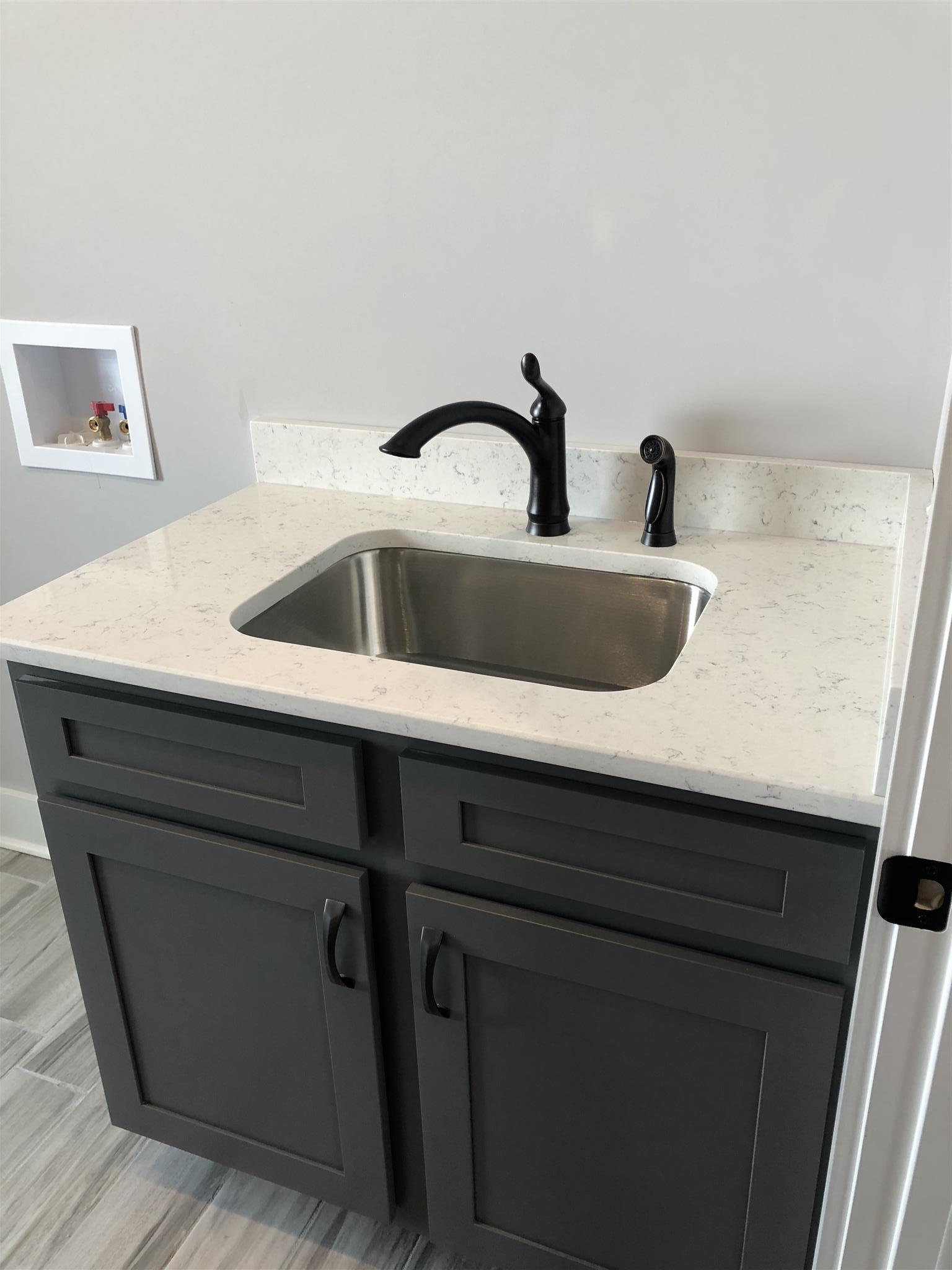 409 Halltown Road Cottontown, TN 37048 - Photo 9 of 25 a bathroom with a sink and vanity