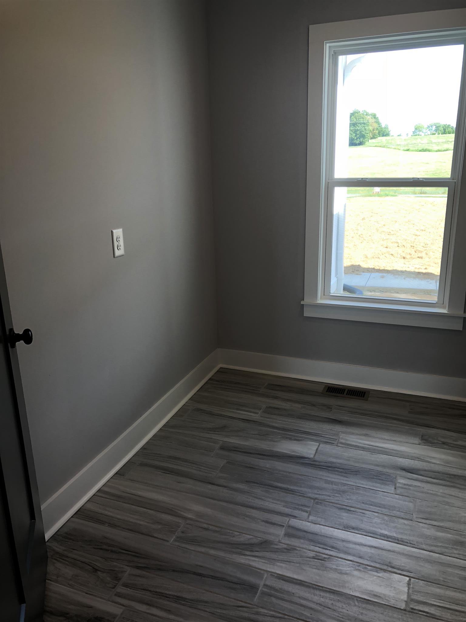 409 Halltown Road Cottontown, TN 37048 - Photo 10 of 25 a view of a room with wooden floor and window