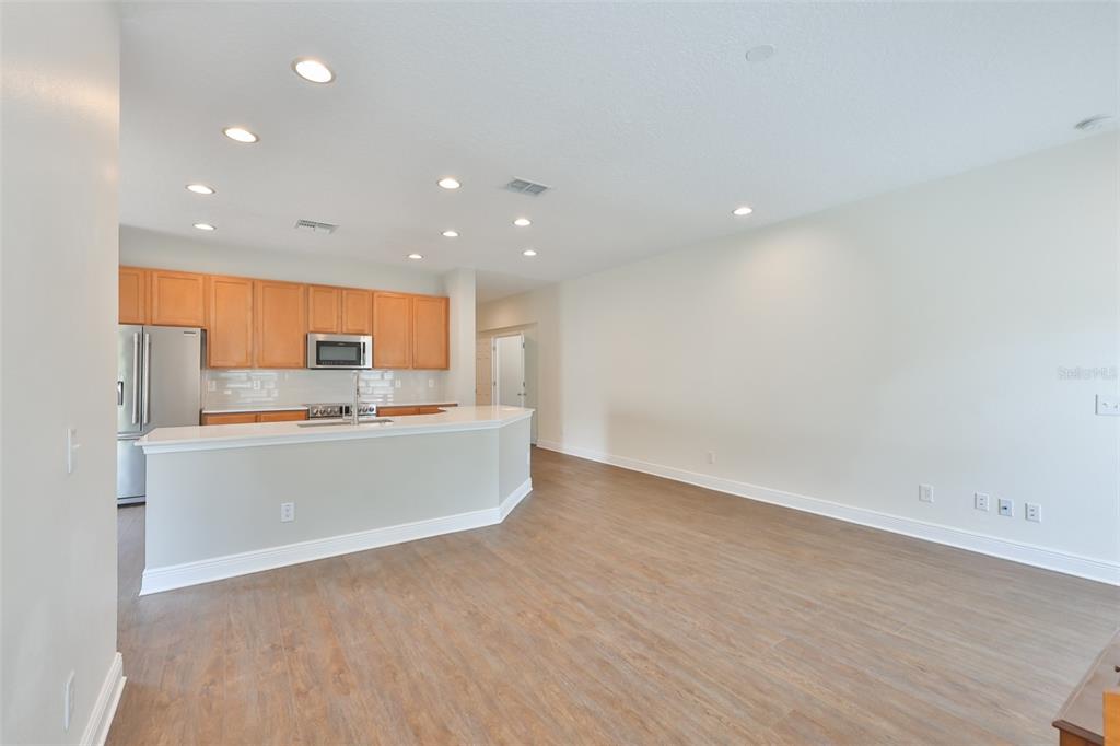 708 Coade Stone Drive Seffner, FL 33584 - Photo 15 of 48 an empty room with wooden floor and windows