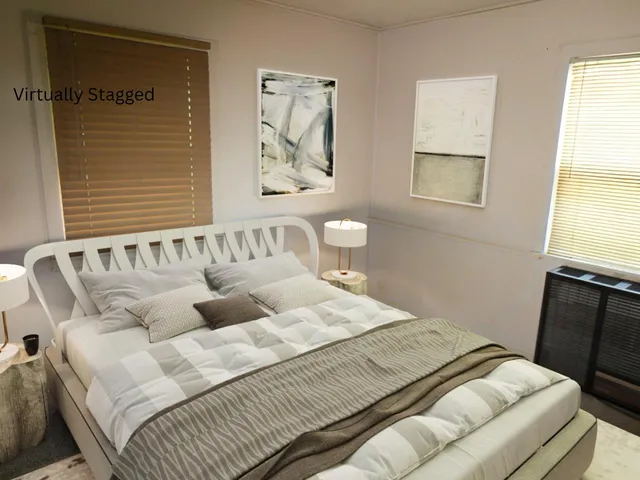 a bedroom with a bed and a window