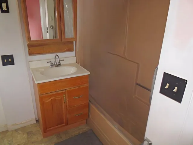 a bathroom with a sink a toilet and vanity