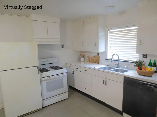 a kitchen with white cabinets and white appliances