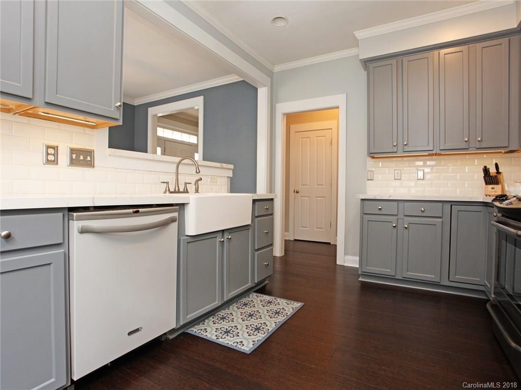 9399 Founders Street, Unit 164 Fort Mill, SC 29708 - Photo 13 of 36 a kitchen with a sink cabinets and wooden floor