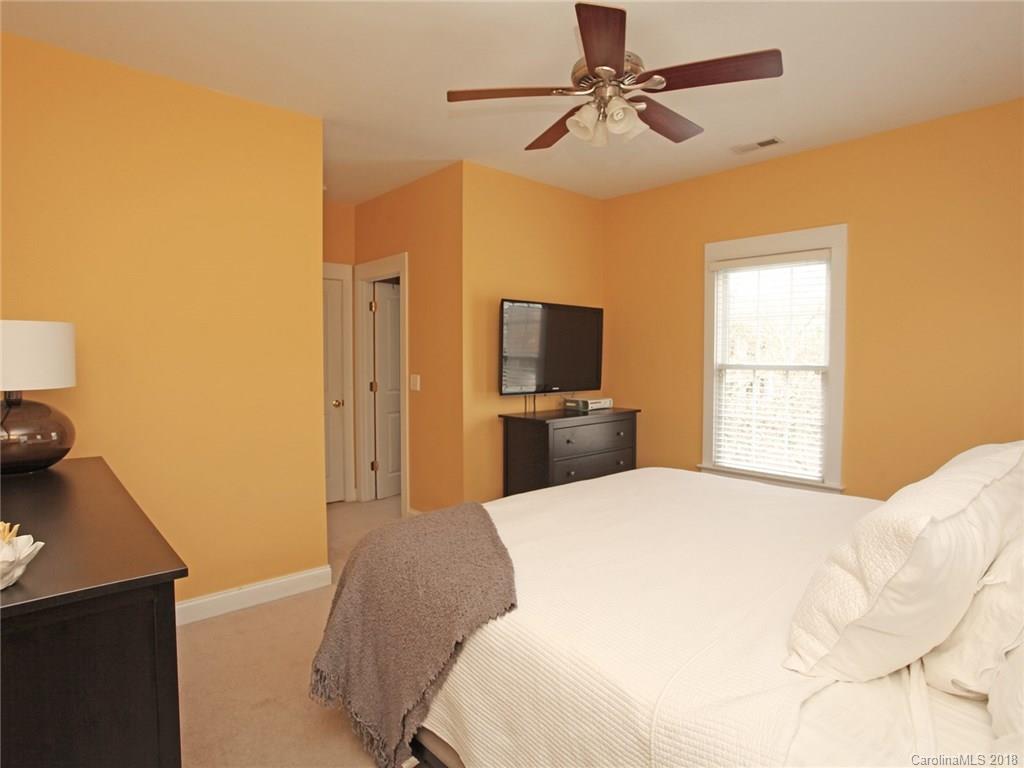 9399 Founders Street, Unit 164 Fort Mill, SC 29708 - Photo 21 of 36 a bedroom with a bed and a flat screen tv