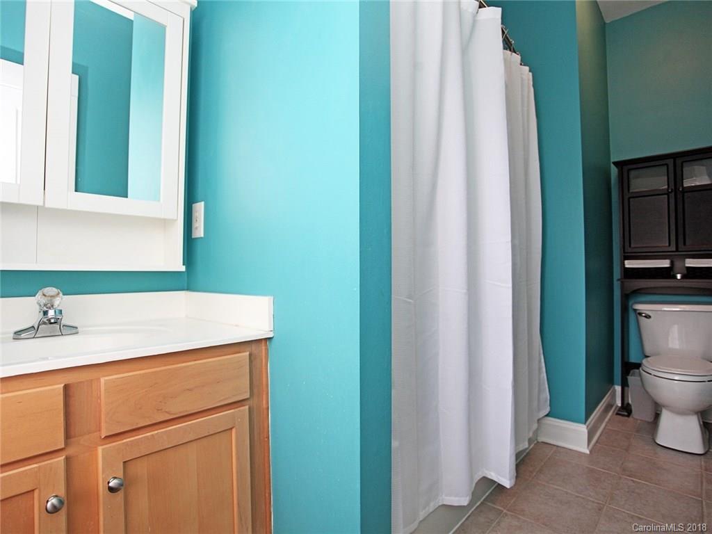 9399 Founders Street, Unit 164 Fort Mill, SC 29708 - Photo 23 of 36 a bathroom with a sink a toilet and a mirror