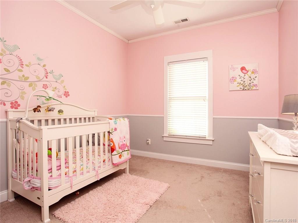 9399 Founders Street, Unit 164 Fort Mill, SC 29708 - Photo 25 of 36 a white bed sitting in a bedroom next to a window