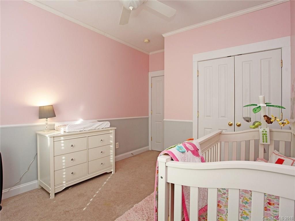 9399 Founders Street, Unit 164 Fort Mill, SC 29708 - Photo 26 of 36 a bedroom with a bed and a cabinets