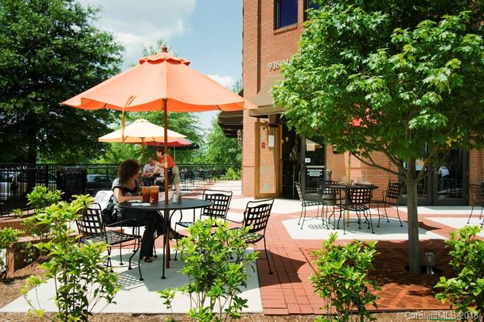 9399 Founders Street, Unit 164 Fort Mill, SC 29708 - Photo 35 of 36 a view of patio with chairs and table under an umbrella