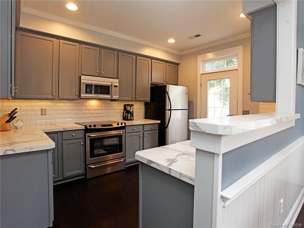 9399 Founders Street, Unit 164 Fort Mill, SC 29708 - Photo 9 of 36 a kitchen with a refrigerator stove and sink