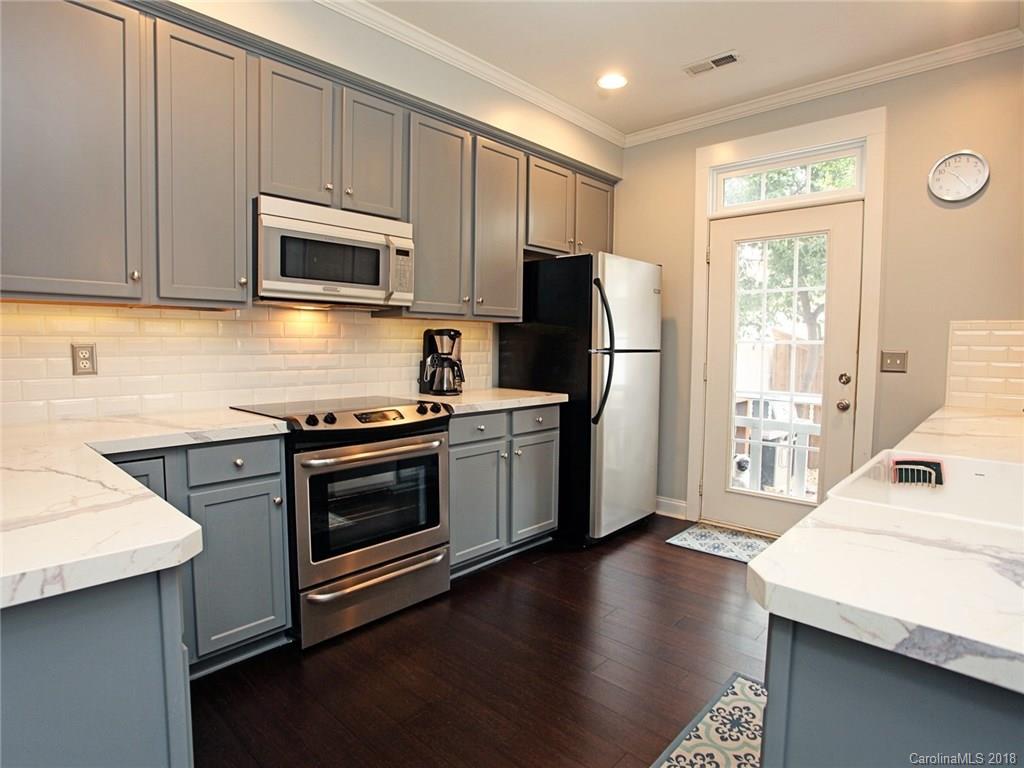 9399 Founders Street, Unit 164 Fort Mill, SC 29708 - Photo 10 of 36 a kitchen with stainless steel appliances a stove microwave and refrigerator