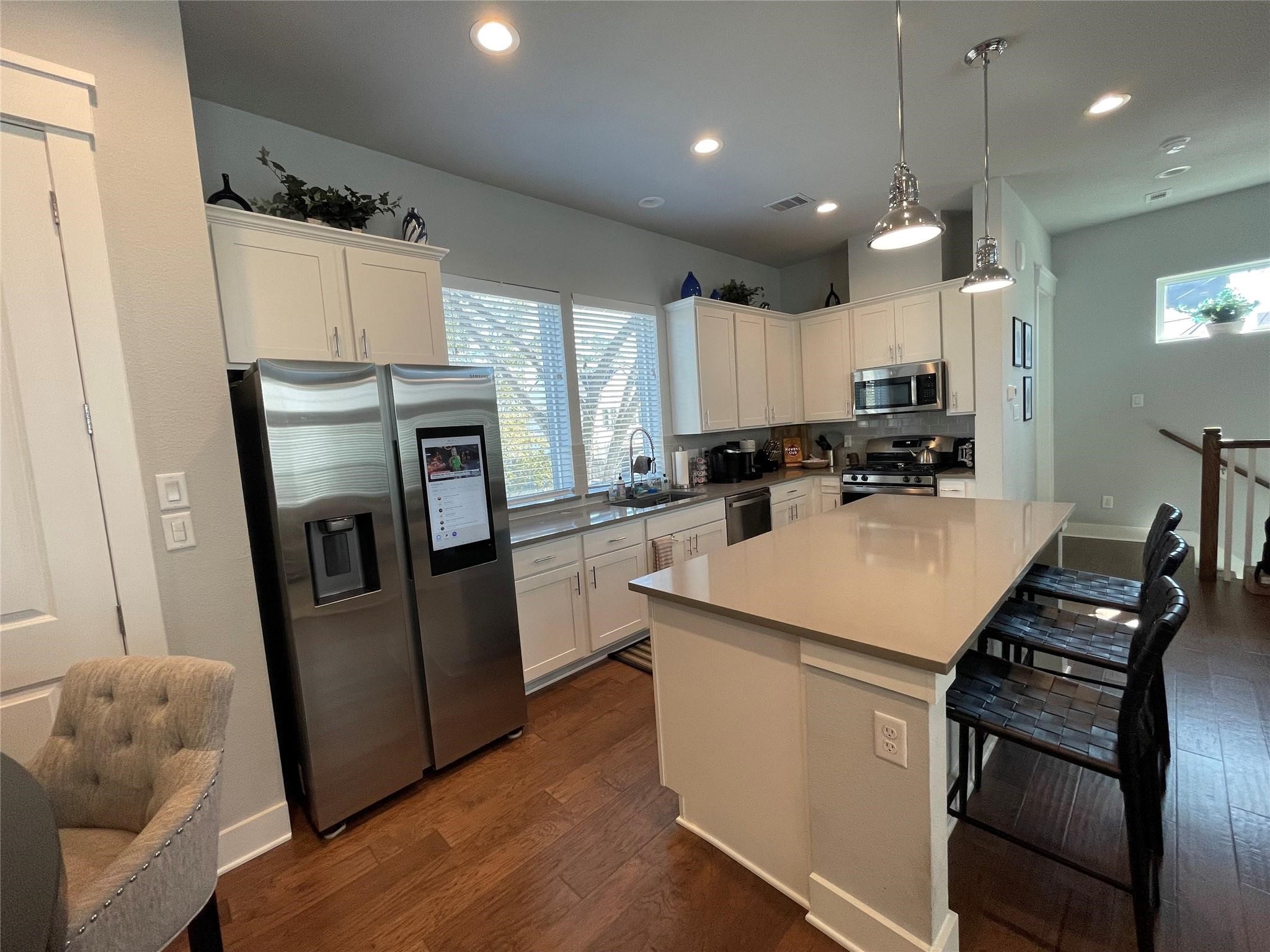 902 Martin Street, Unit A Houston, TX 77018 - Photo 5 of 21 a kitchen with refrigerator a sink a stove and cabinets