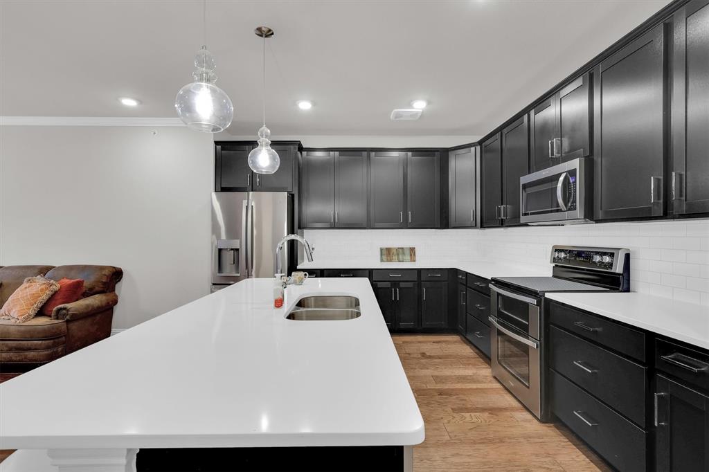 651 Watters Road, Unit 2105 Allen, TX 75013 - Photo 2 of 32 a kitchen with stainless steel appliances granite countertop a sink a stove and a refrigerator