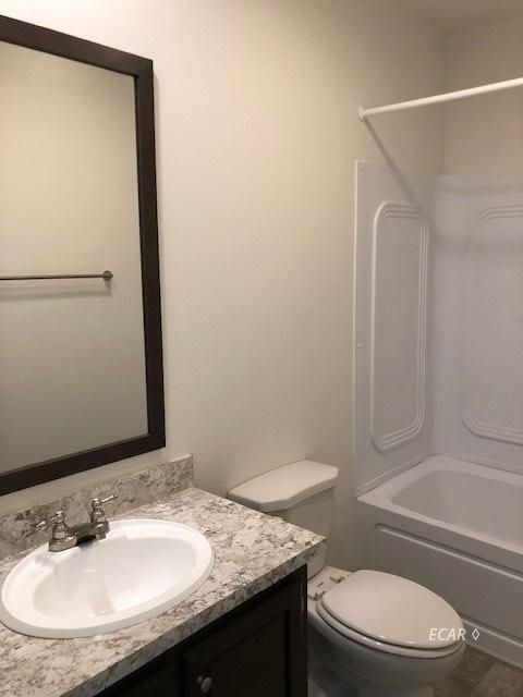 921 Spring Valley Parkway Spring Creek, NV 89815 - Photo 10 of 12 a bathroom with a granite countertop sink toilet and shower