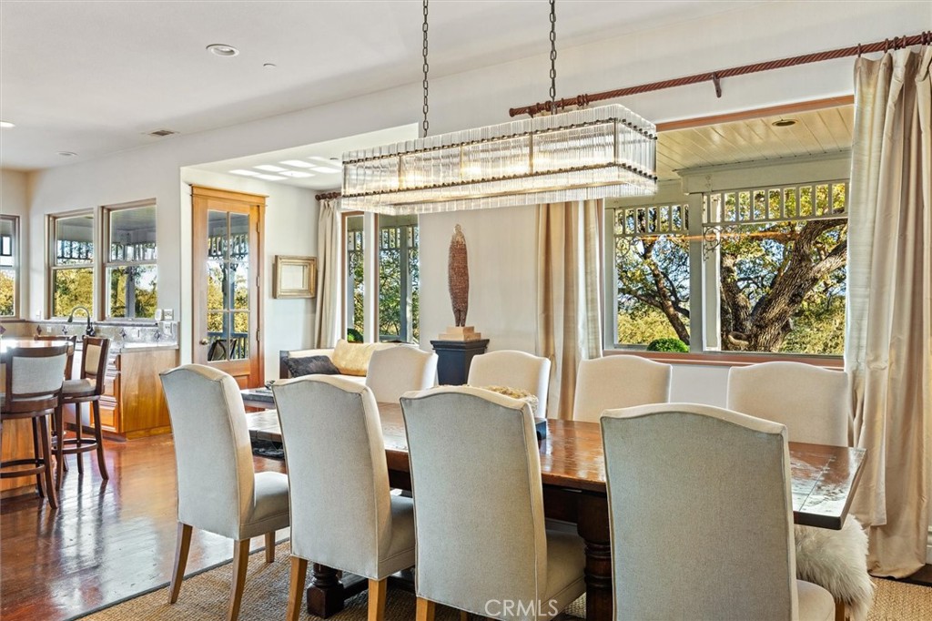 6970 Benton Road Paso Robles, CA 93446 - Photo 33 of 74 a view of a dining room with furniture large windows and wooden floor