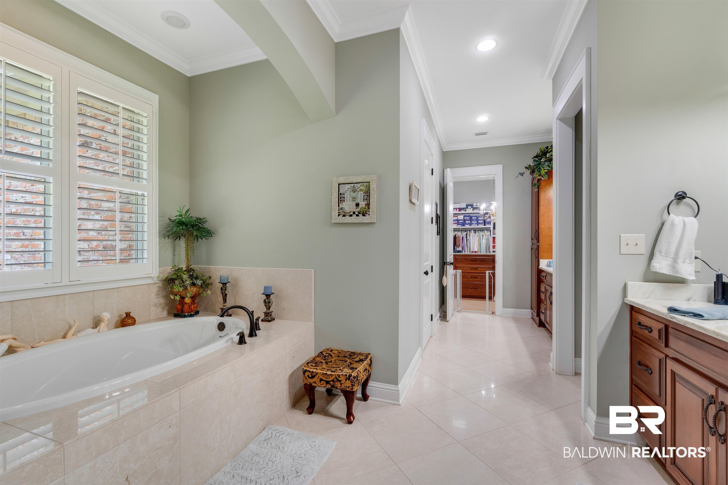 11281 Redfern Road Daphne, AL 36526 - Photo 28 of 80 Bathroom featuring tile patterned flooring, a relaxing tiled tub, crown molding, and vanity