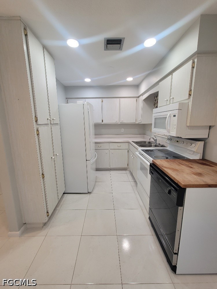 347 Richland Road Lehigh Acres, FL 33936 - Photo 5 of 16 a kitchen with stainless steel appliances granite countertop a sink and a stove