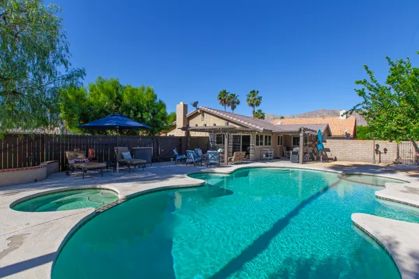 swimming pool view with a seating space