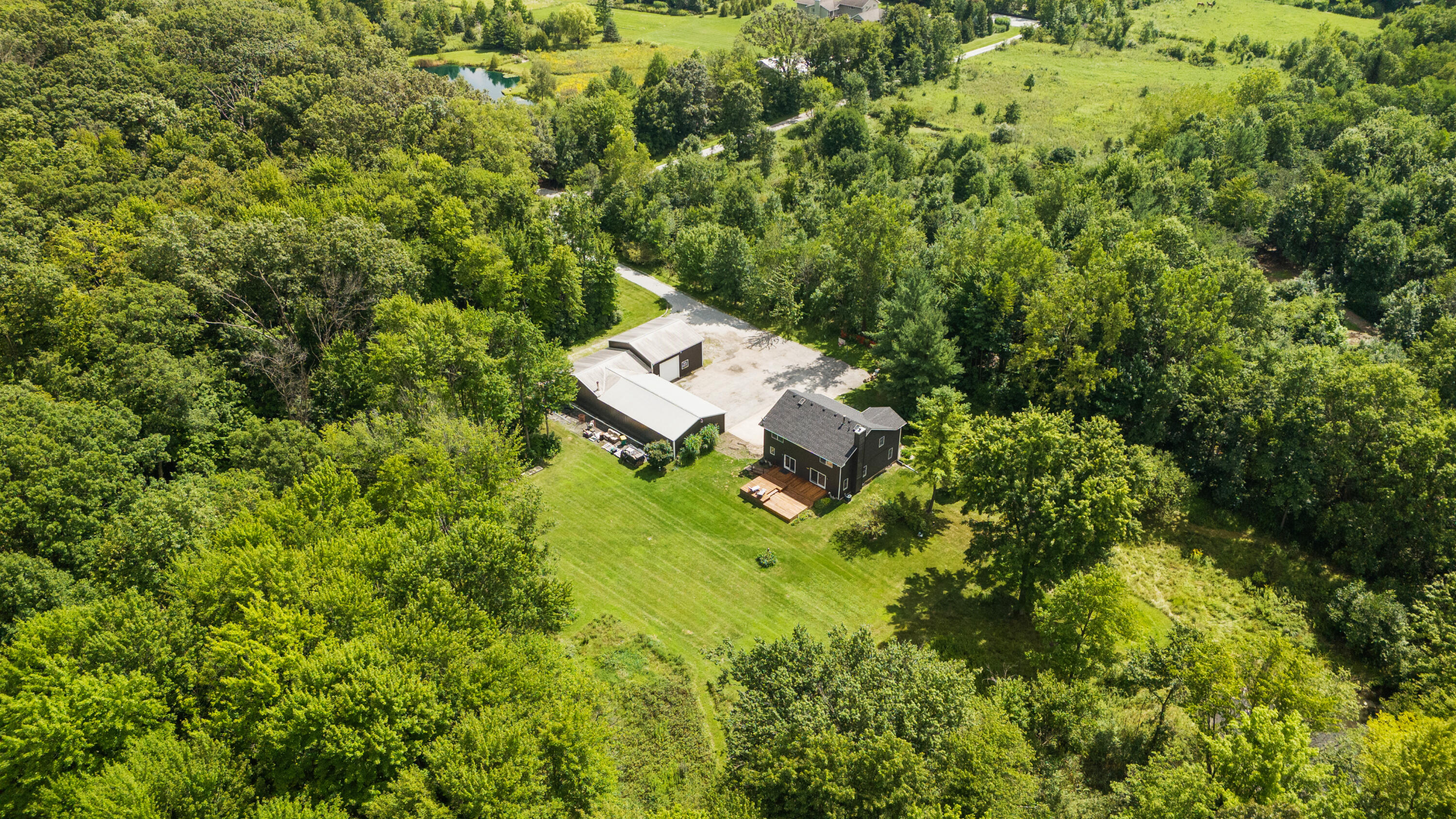 an aerial view of a house with a yard