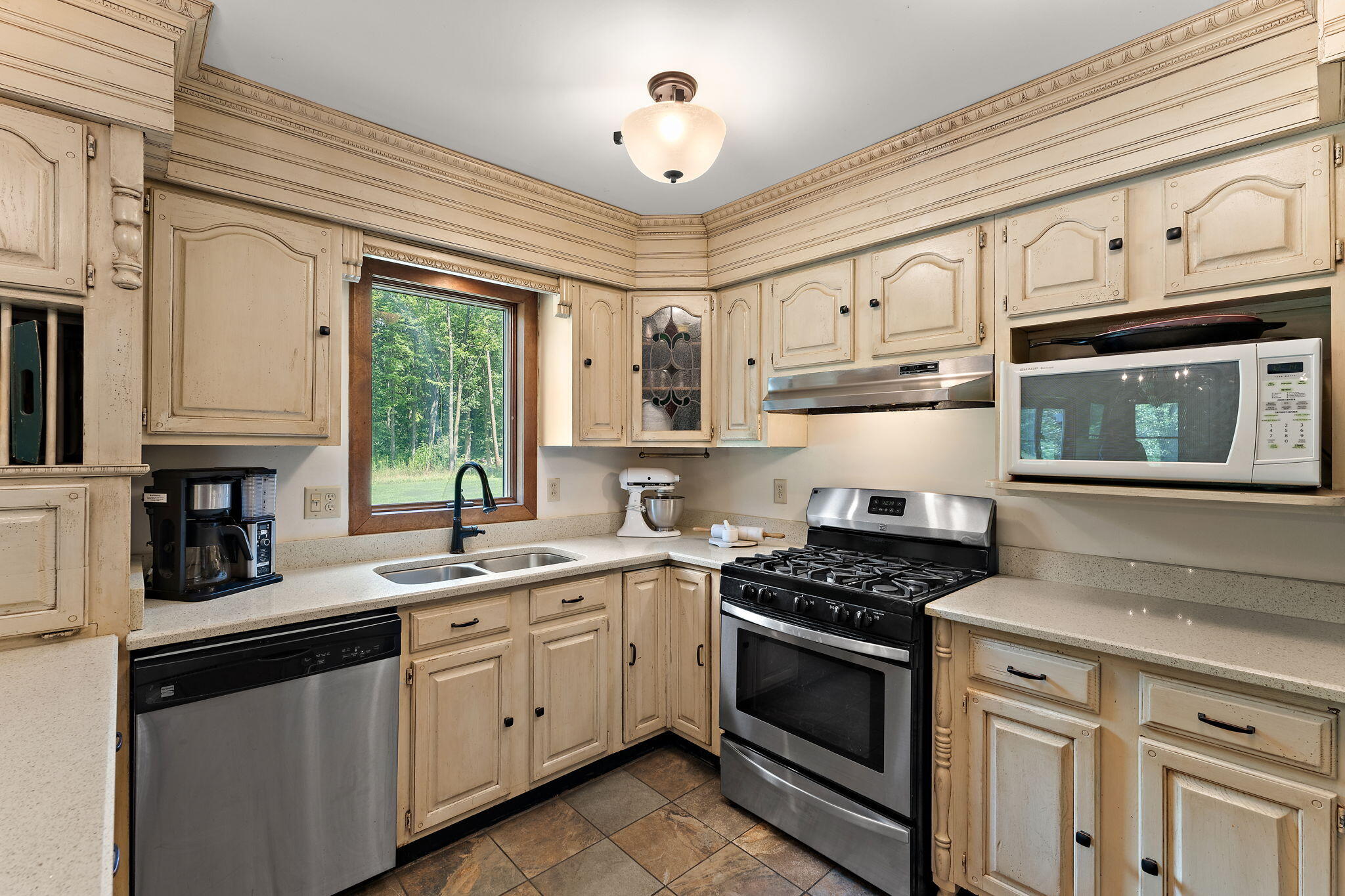 249 West 700 North Valparaiso, IN 46385 - Photo 15 of 46 a kitchen with cabinets appliances a sink and a window