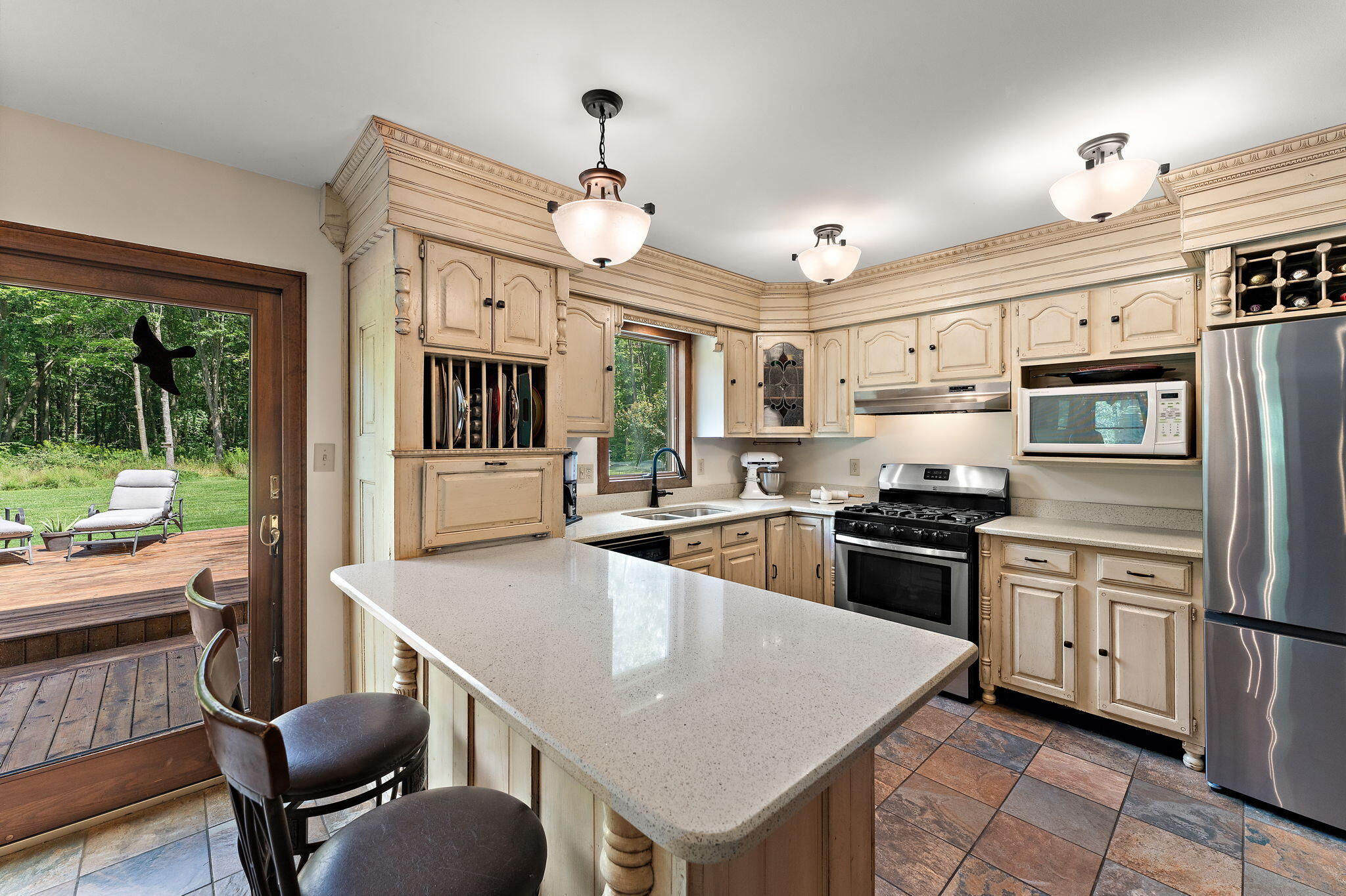 249 West 700 North Valparaiso, IN 46385 - Photo 17 of 46 a kitchen with stainless steel appliances granite countertop a stove a refrigerator a kitchen island a sink dishwasher a dining table and chairs with wooden floor