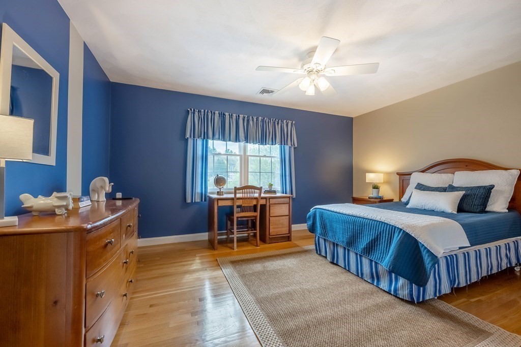 2 Hay Bale Road Andover, MA 01810 - Photo 25 of 42 a bedroom with a bed and a chandelier